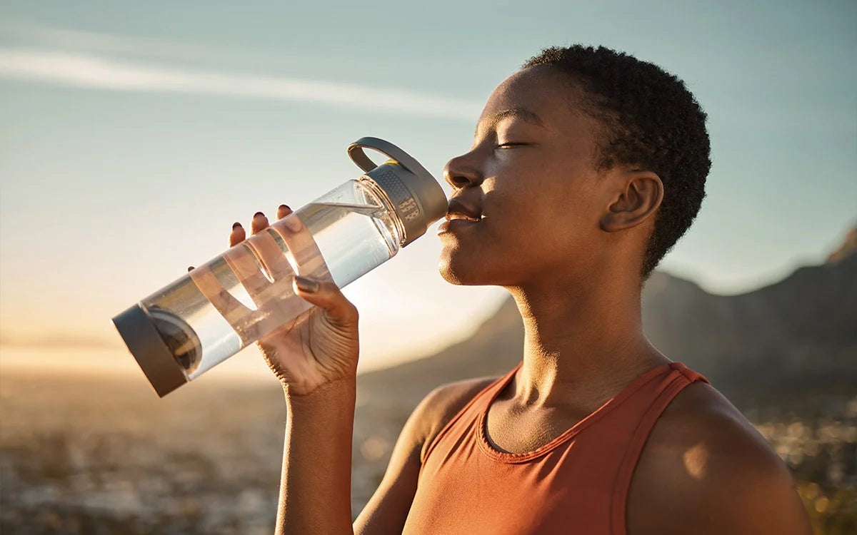 Woman drinking water to hydrate