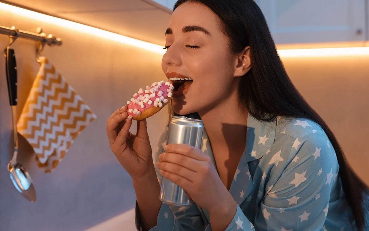 Woman eating a high sugar doughnut