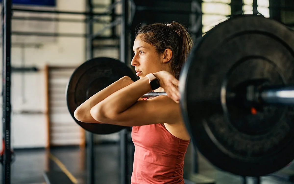 Woman In Gym Lifting Heavy Weights