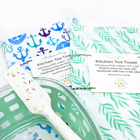 blue nautical Anchors Away kitchen tea towel and green watercolor Eucalyptus fun tea towel by Sunny Day Designs