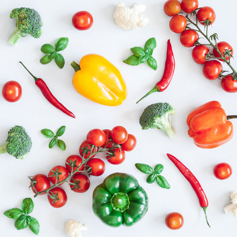 Colorful and fresh red, yellow, green, and white vegetables on a white background