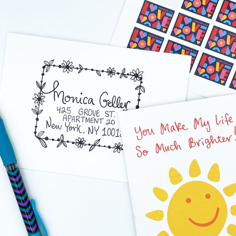 Drawn Ink Floral Rectangle Border Around Address on White Envelope with Love Postage Stamps and Yellow Smiling Sun Greeting Card by Sunny Day Designs - Snail Mail Fun Blog Post