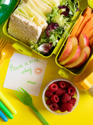 Childe's lunch box with food and a handwritten note from their mom