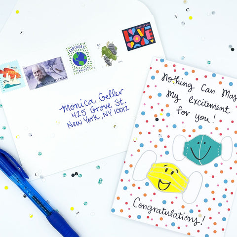 White Envelope with 5 Fun and Colorful Postage Stamps, confetti, a blue pen, and the COVID Congrats celebration greeting card by Sunny Day Designs - Snail Mail Fun Blog Post