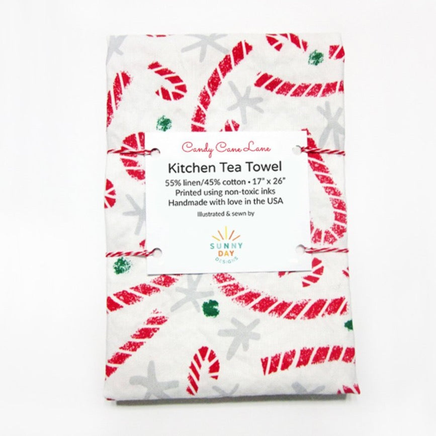 https://cdn.shopify.com/s/files/1/0430/4057/1556/products/Candy-Cane-Lane-Kitchen-Tea-Towel-Packaged-Sunny-Day-Designs-LowRes_1024x1024.jpg?v=1612122531