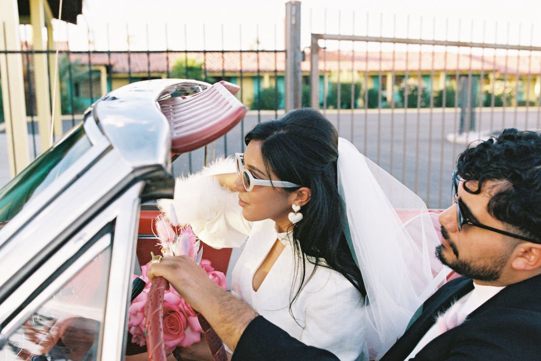 Bride Karla and groom Ramiro elope in their retro convertible at Sure Thing Chapel