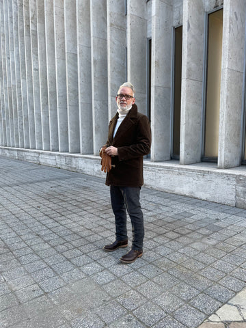 Model wearing RYAN Originals corduroy coat in brown and Turtleneck sweater from Merz B. Schwanen in white