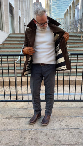 Model wearing brown corduroy coat with black and white wool and cotton blend liner and white turtleneck 