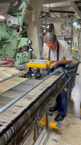 Man working on weaving the fabric for the liner