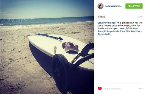 Instagram customer with their board on the beach