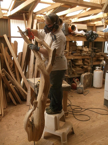 Stephanie sanding Blue Moon outdoor sculpture