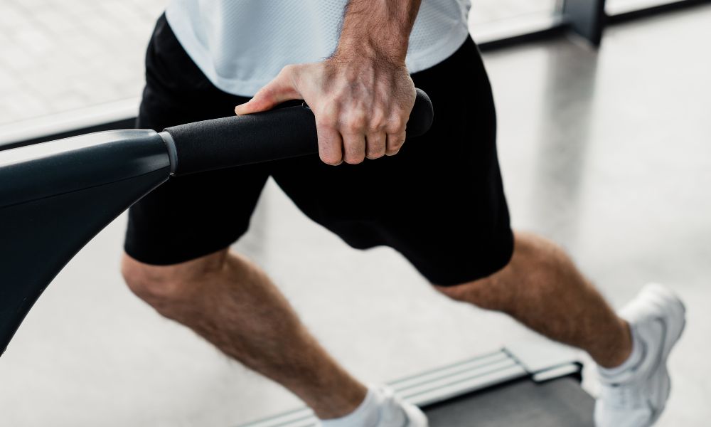 Why You Need To Stop Holding the Treadmill Handrails