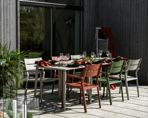 Brafab Nimes Outdoor Dining Table in kharki shown with Brafab Delia outdoor dining chairs in moss green, burnt paprika and kharki