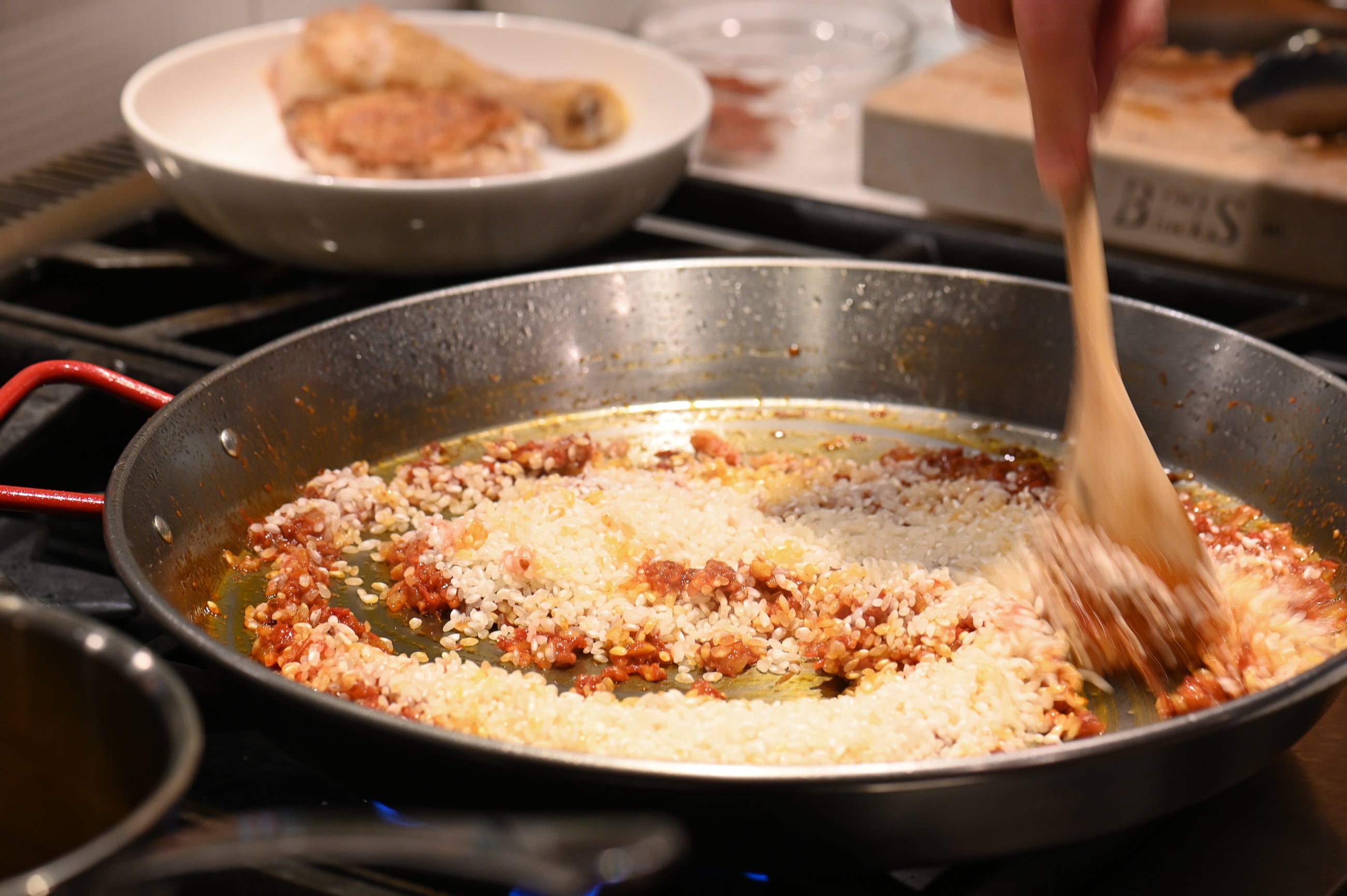 mixing rice in the paella pan