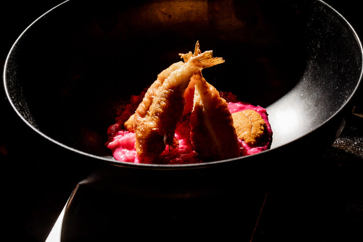 fried blowfish tails over pink risotto
