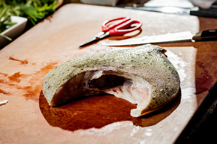 Turbot with head removed on cutting board