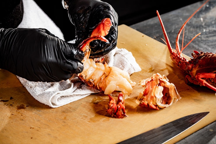 Chef hands removing spiny lobster shell