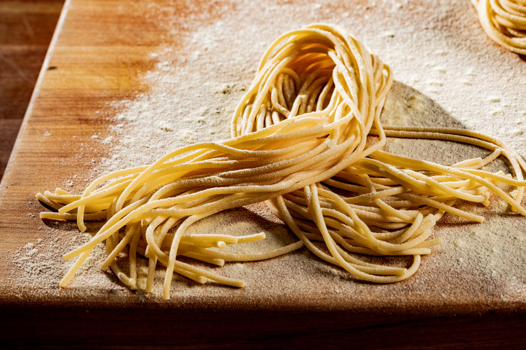 fresh spaghetti arranged in a loop