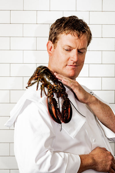 chef petting lobster on his shoulder