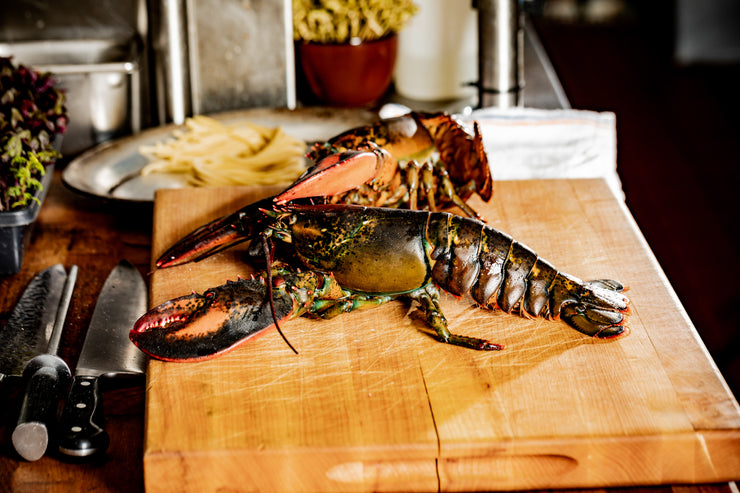 lobster sitting on cutting board