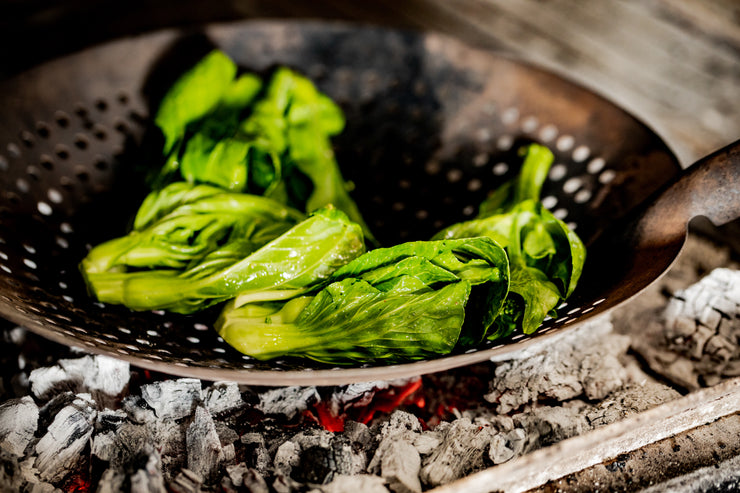 bok choy cooking over charcoal