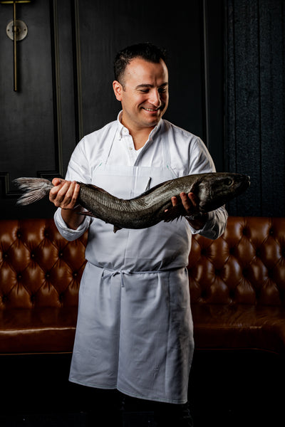 chef val m cantu holding whole black cod 