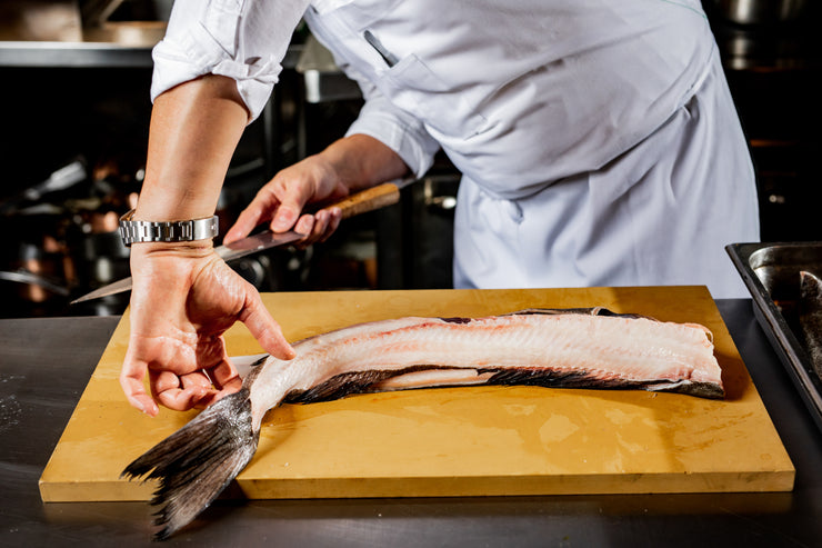 Man preparing black cod to cook
