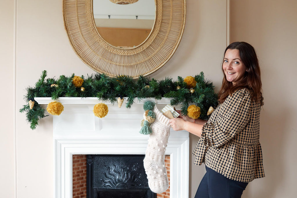 Lindsey hanging stocking on mantle piece