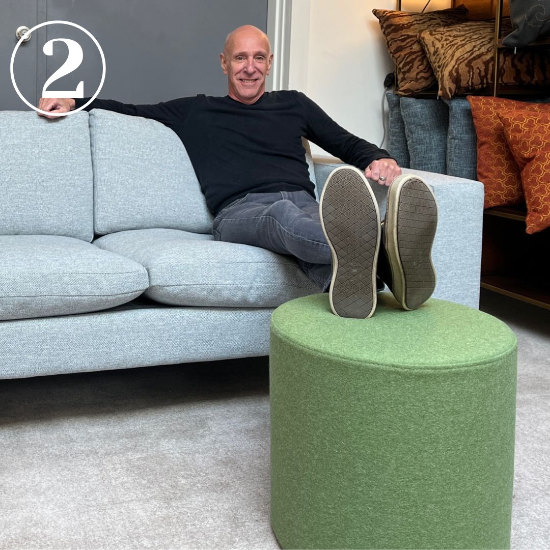 Person sitting on sofa with feet on Bumper ottoman