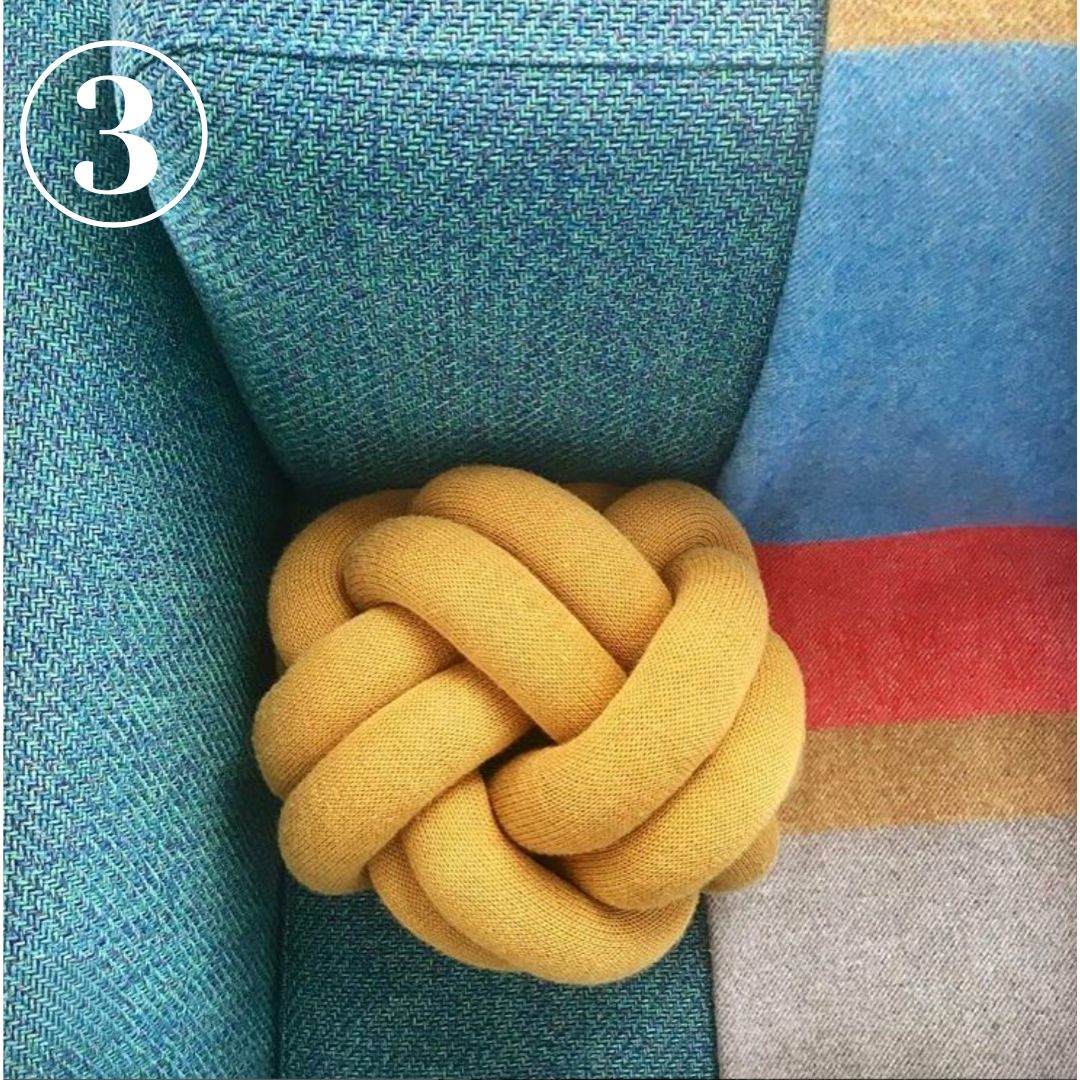 Knot Pillow on corner of sofa view from above