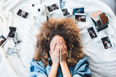 Woman surrounded by polaroid photos