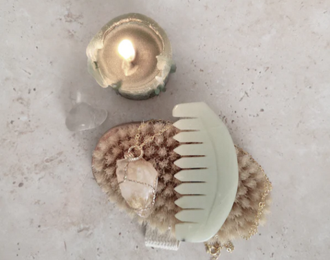 candle and gua sha comb