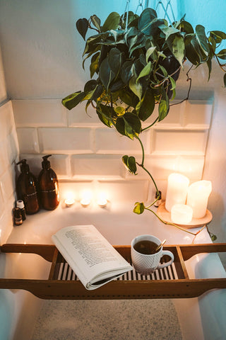 candles, book, tea, in a bath setting
