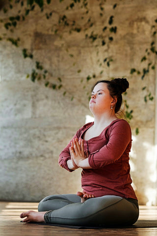 woman meditating indoors