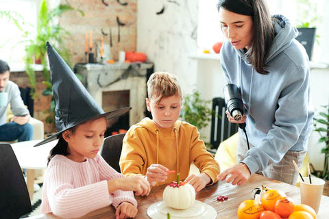 Family making arts and crafts with pumpkins