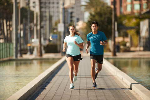 Man and Woman Running in Hoka Running Shoes