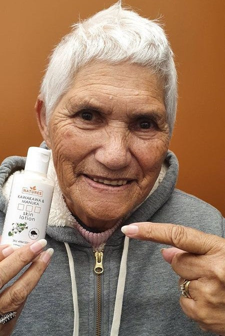 Photo of O E. holding Natures Therapeutics Kawakawa & Mānuka Skin Lotion