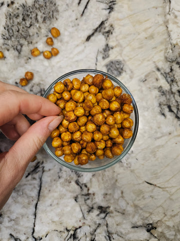 a glass bowl of seasoned and air fried chick peas