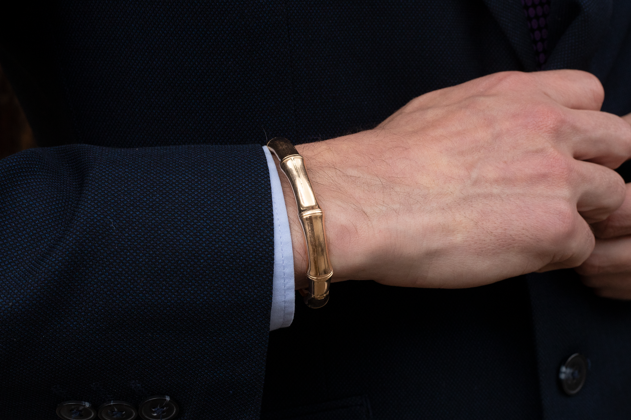 Bamboo bangle for men and female in yellow gold on a mans wrist