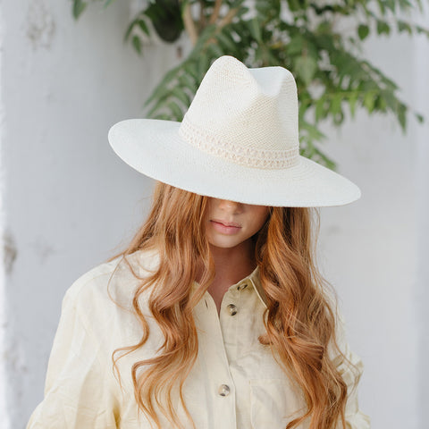 redhead woman with ivory straw hat