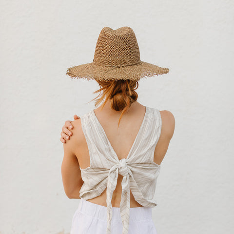 redhead woman with brown straw hat