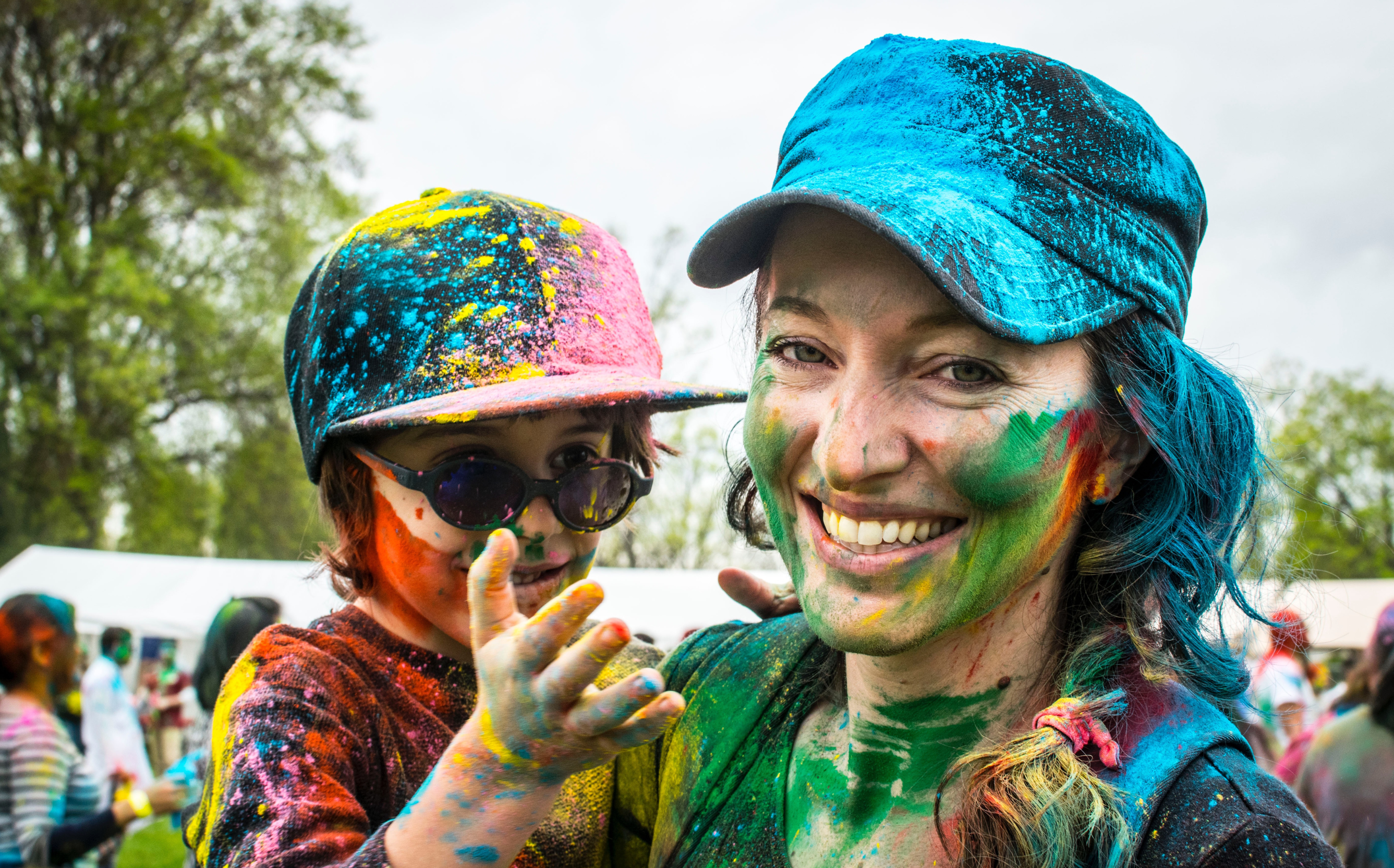 Mother and child pose together at a color festival