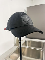 wet black hat on hatstand