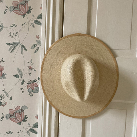 panama palm straw hat hanging on wall