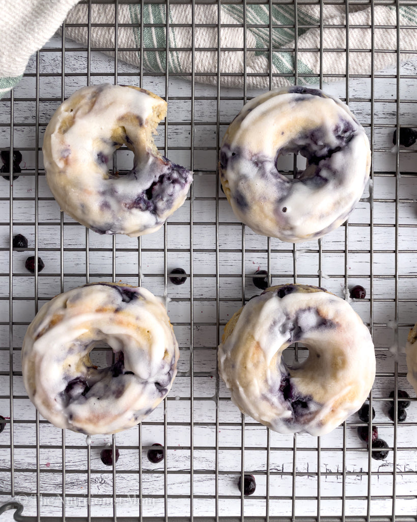 four Blueberry GlazedProtein Donuts one with bite