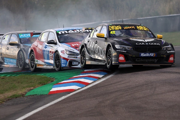 Trail of BTCC cars racing with Adam Morgan at the front