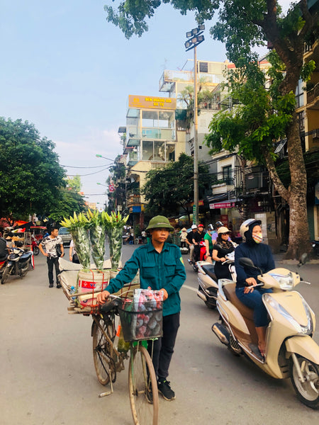 Man carrying flowers in vietnam