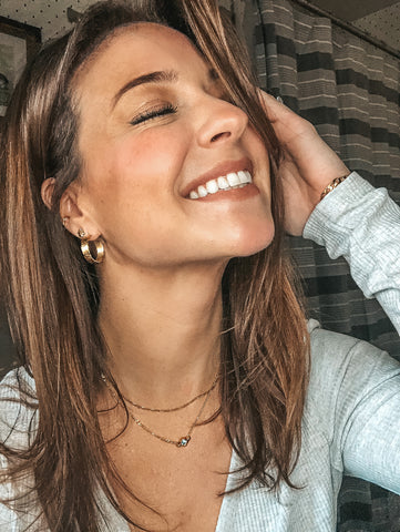 Girl smiling wearing gold jewellery