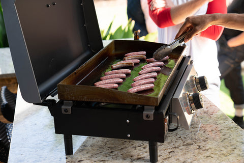 cooking sausage on a griddle