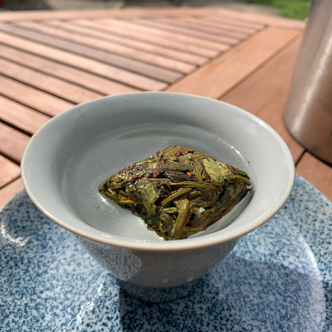 Zhangping Shuixian mini brick floating in a gaiwan